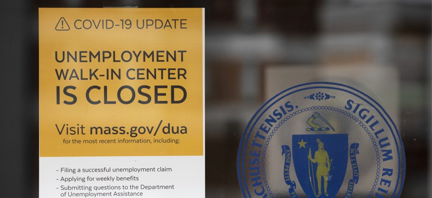 A sign outside of the Massachusetts Unemployment Office. Unemployment claims are severely straining the legacy systems states use to process them.