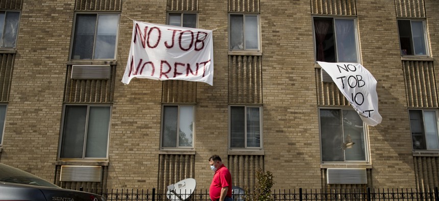  In this May 20, 2020, file photo, signs that read "No Job No Rent" hang from the windows of an apartment building during the coronavirus pandemic in northwest Washington, D.C.