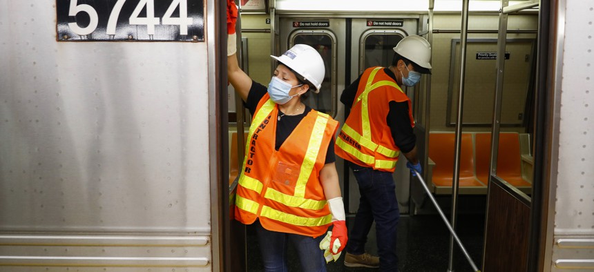Contractors clean subway cars at the 96th Street station in New York City to try to control the spread of Covid-19.