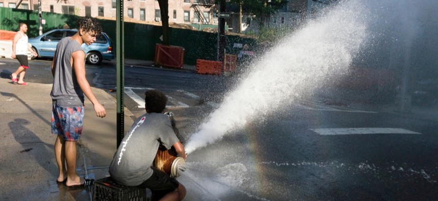 Children in the Bronx, New York, use a fire hydrant to cool off.