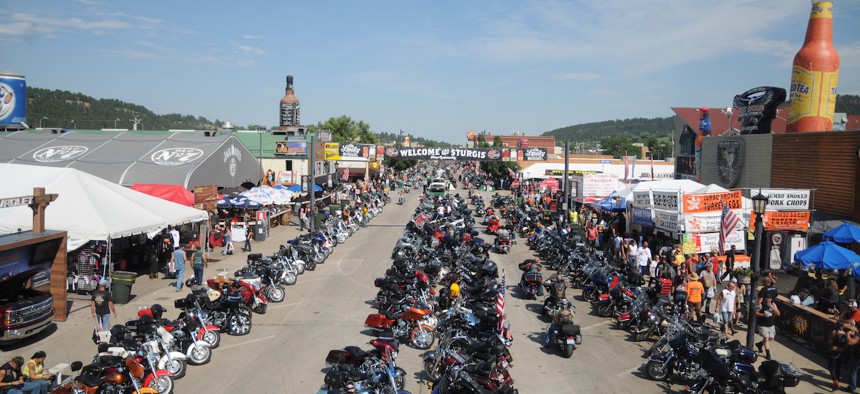 In this Aug. 5, 2015, file photo, motorcycles stretch down Main Street in Sturgis, S.D., for the landmark Sturgis Motorcycle Rally. About 250,000 people are expected for this year's event, which is proceeding despite local concerns about Covid-19.