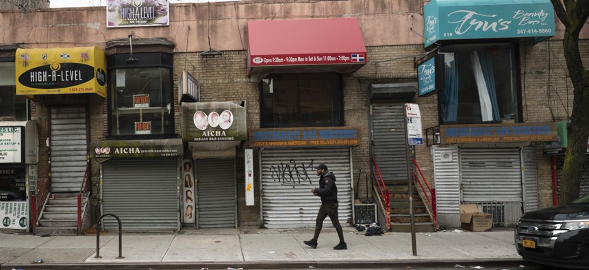 In this April 8, 2020, photo, small businesses are shuttered closed during the coronavirus epidemic in the Crown Heights neighborhood of the Brooklyn borough in New York.