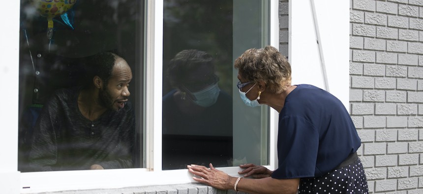 Southern Pines nursing home resident Wayne Swint gets a birthday visit from his mother, Clemittee Swint, in Warner Robins, Ga. in June. Staff members at facilities across the country are arranging window visits as face-to-face visits remain off-limits.