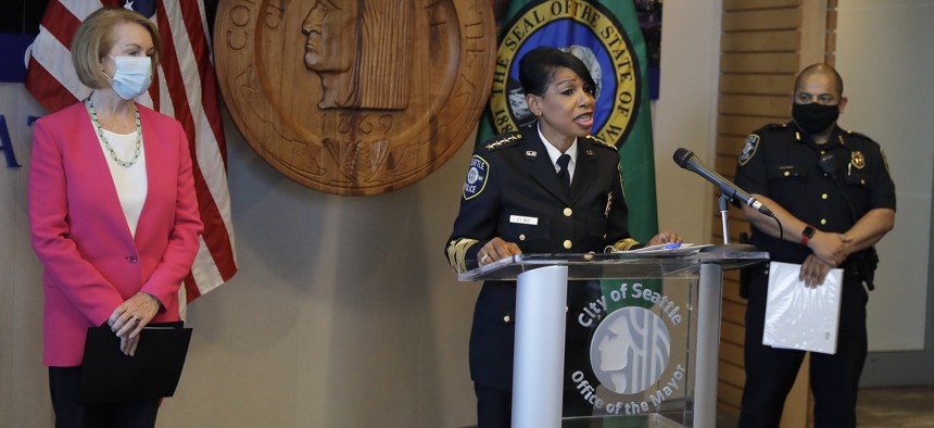 Seattle Police Chief Carmen Best, center, speaks as Seattle Mayor Jenny Durkan, left, and Deputy Police Chief Adrian Diaz, right, look on during a news conference on Aug. 11, 2020, in Seattle. 