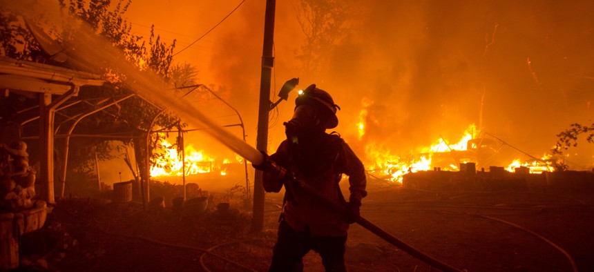 A firefighter works against the Lake Hughes fire in Angeles National Forest on August 12, 2020.