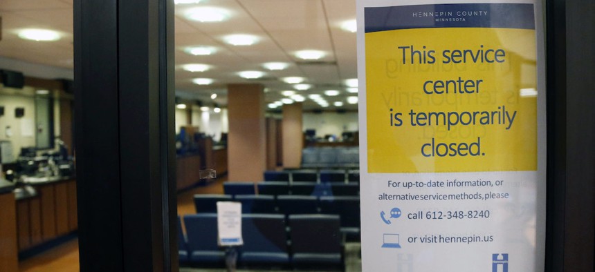The Hennepin County Government Center service center stands closed Tuesday, March 17, 2020 in Minneapolis where efforts to slow the spread of the coronavirus continue. (AP Photo/Jim Mone)