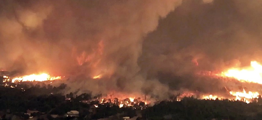 This July 26, 2018 file image taken from video released by Cal Fire shows a fire tornado over Lake Keswick Estates near Redding, Calif. 