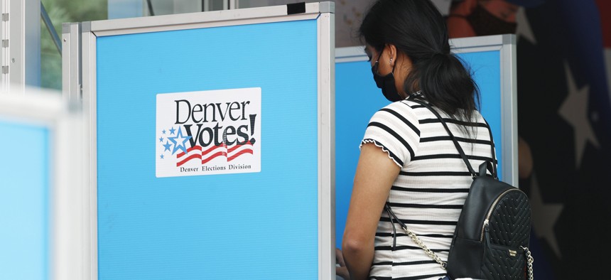A voter casts a ballot in Denver during Colorado's June 2020 primary election. 