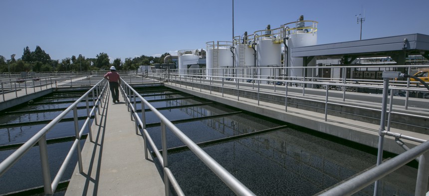A supervisor tours the Secondary Treatment Clarifiers tanks at the Los Angeles Sanitation plant where millions of gallons of wastewater are purified each day in Van Nuys, Calif., Wednesday, May 20, 2015. 