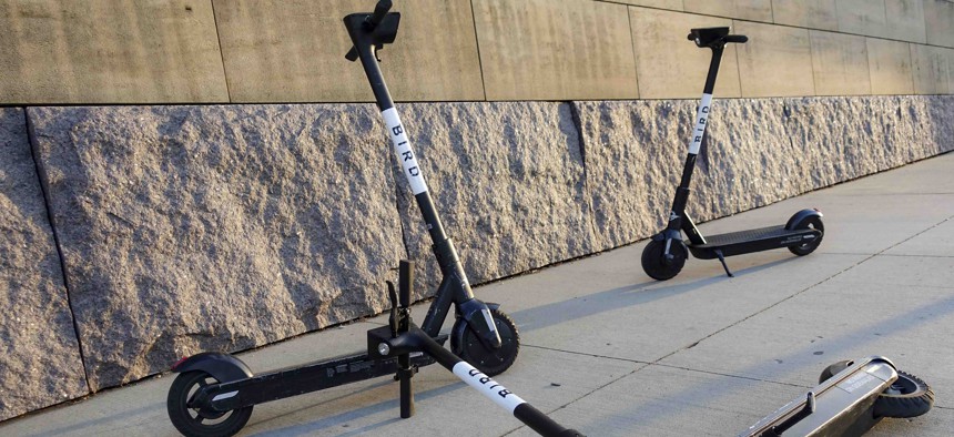 Sharable electric scooters by Bird Rides, Inc. wait on downtown sidewalks for pedestrian use, Wednesday, Oct. 2, 2019, in downtown Cincinnati.