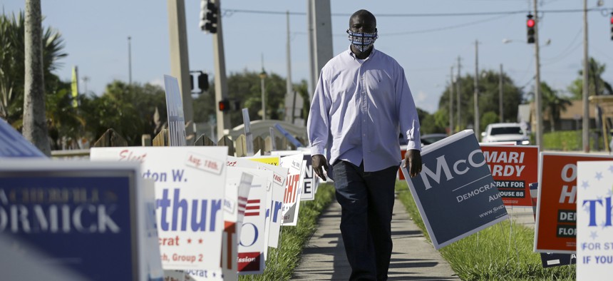 William Freeman, a formerly incarcerated person who registered to vote recently, walks outside his polling station in Riviera Beach, Florida. Efforts to raise money so that people with criminal records in the state can vote have raised millions. 