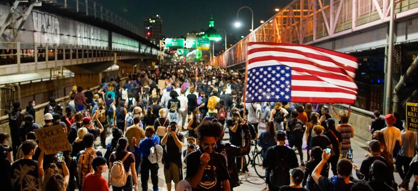 Demonstrators march on the Williamsburg Bridge during a protest, Wednesday, Sept. 23, 2020, in New York, following a Kentucky grand jury's decision not to indict any police officers for the killing of Breonna Taylor. (AP Photo/Eduardo Munoz Alvarez)