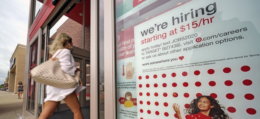In this Sept. 2, 2020, file photo, a help wanted sign hangs on the door of a Target store in Uniontown, Pa. Despite gains, there were signs job growth was slowing last month.