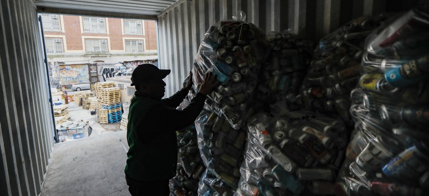 Manuel Rene Del Carmen organizes bags of recyclables on a roof at the Sure We Can, a Brooklyn non-profit redemption center Thursday, Feb. 27, 2020, in New York.