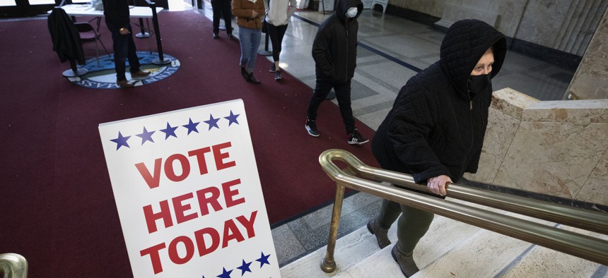 Voters stand in line for early voting in Massachusetts. The state has a ballot initiative that, if passed, would implement ranked choice voting. 