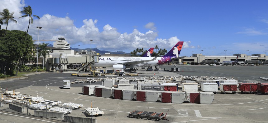An airplane is seen parked at a terminal at the the Daniel K. Inouye International Airport Thursday, Oct. 15, 2020, in Honolulu. Hawaii has suffered outsized job losses in its tourism sector as the pandemic halted travel to the islands.