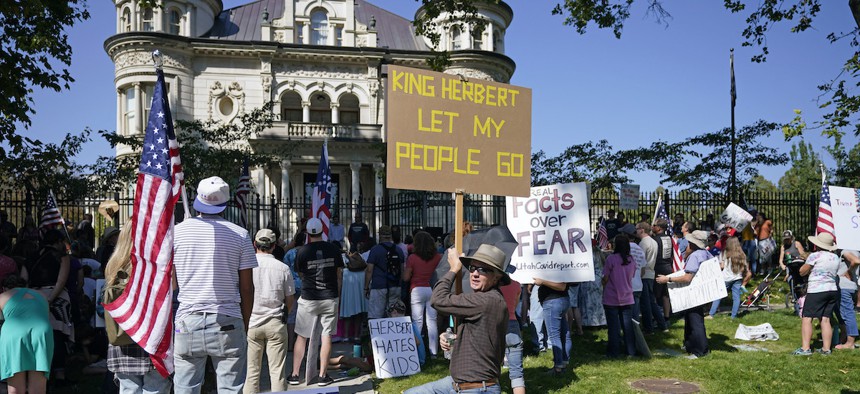 In this Sept. 12, 2020, file photo, people protest Gov. Gary Herbert during an anti-mask rally outside of the Governors Mansion in Salt Lake City. Protests have since spread to Herbert's private home in Orem, Utah.