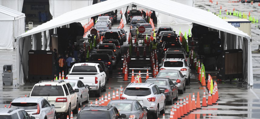 Cars wait in line at the Coronavirus (COVID-19) drive in testing site, set up in the parking lot of Hard Rock Stadium as Florida reported more than 5,838 new cases of COVID-19 on November 12, 2020 in Miami Gardens, Florida. 