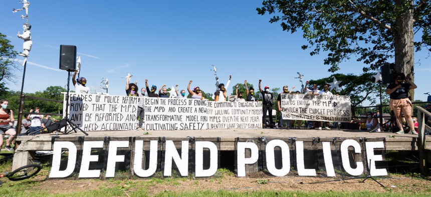 Activists call for defunding the police at a protest in Minneapolis in June.