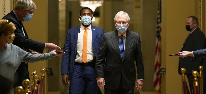 Senate Majority Leader Mitch McConnell of Ky., walks past reporters on Capitol Hill in Washington, Tuesday, Dec. 15, 2020.