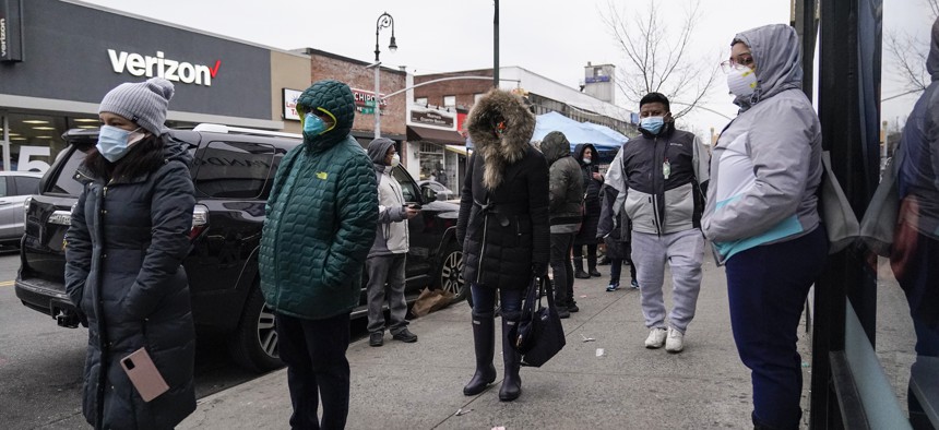 People wait on a line for a CityMD Urgent Care location on Dec. 16, 2020, in the Forest Hills neighborhood of the Queens borough of New York.