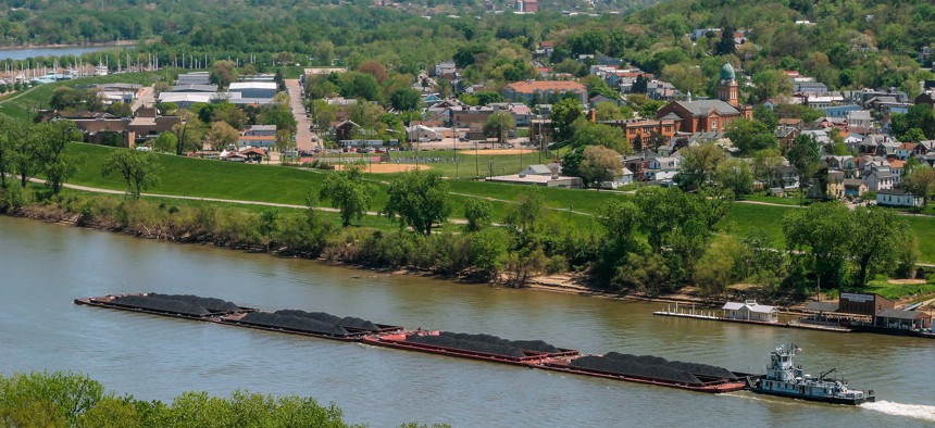 Coal barges are pushed by a boat on the Ohio River.