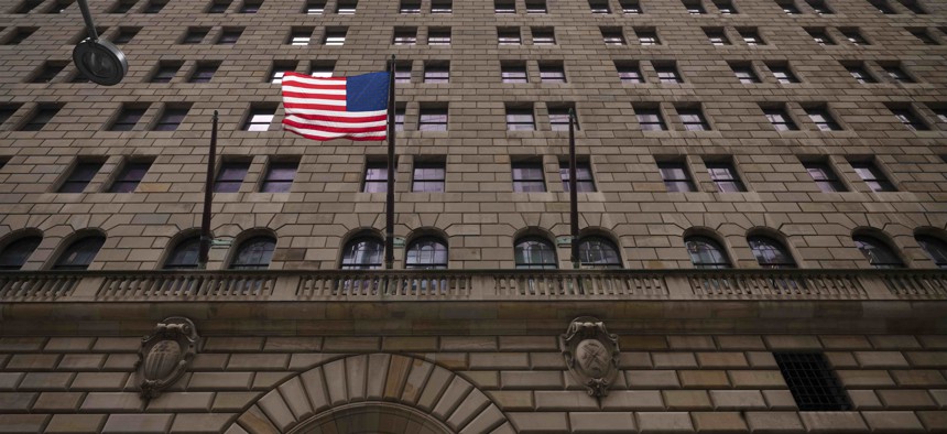 The United States flag hangs on the Federal Reserve Bank of New York, Tuesday, Aug. 4, 2020.