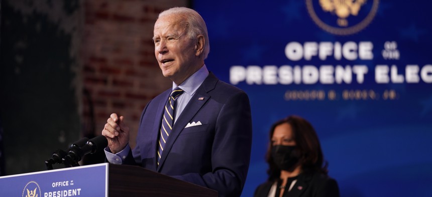President-elect Joe Biden speaks at The Queen theater, Monday, Dec. 28, 2020, in Wilmington, Del. Vice President-elect Kamala Harris listens at right.