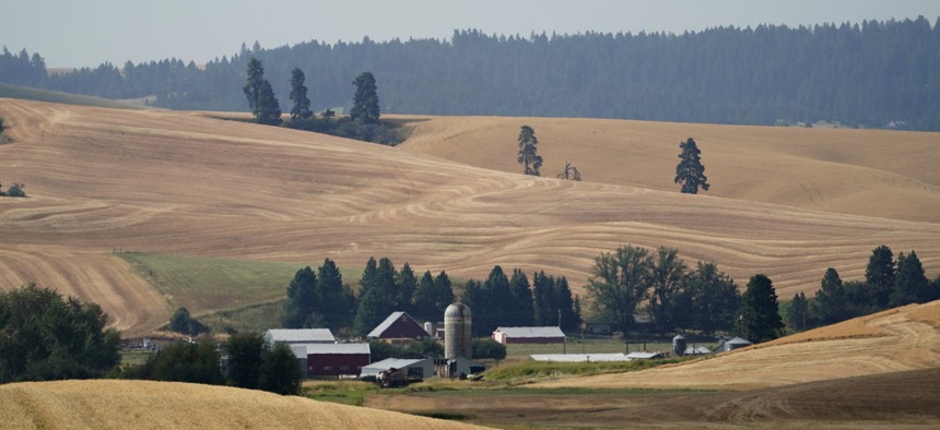 Freshly cut wheat fields are shown near a farm, Tuesday, Aug. 18, 2020, near Moscow, Idaho. Harvest is in full swing in the region known as the Palouse.