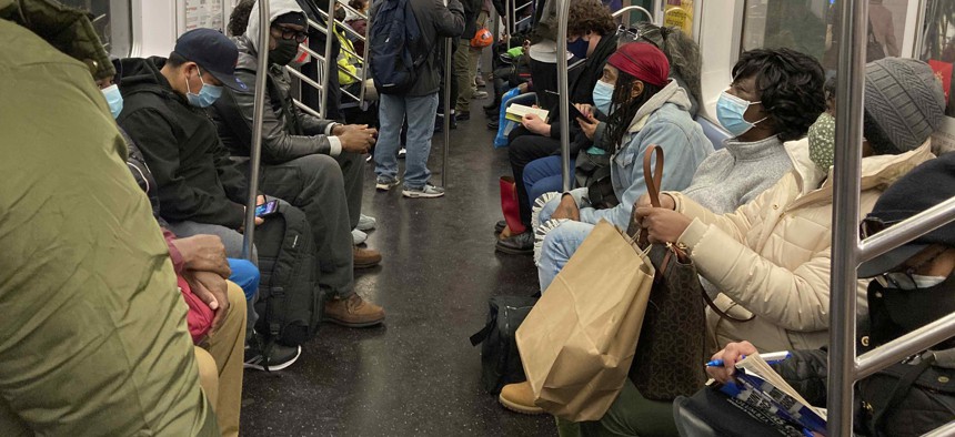 People ride on a subway train in New York City in December 2020.