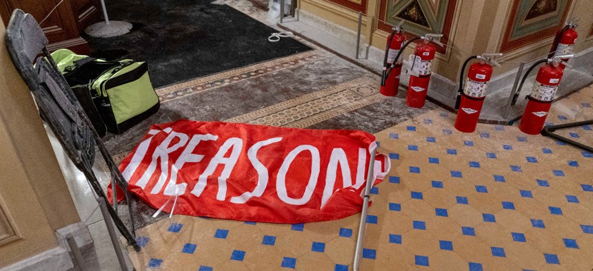 A flag that reads "Treason" is visible on the ground in the early morning hours of Thursday, Jan. 7, 2021.