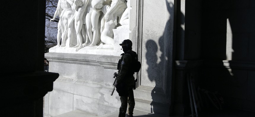 A Capitol police officer stands at the front entrance of the Pennsylvania Capitol building Tuesday Jan. 12, 2021, in Harrisburg, Pa.