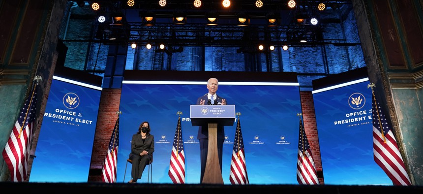 President-elect Joe Biden speaks about the COVID-19 pandemic during an event at The Queen theater, Thursday, Jan. 14, 2021, in Wilmington, Del., as Vice President-elect Kamala Harris listens. 