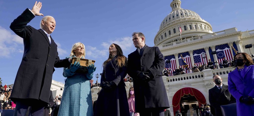 Joe Biden is sworn in as the 46th president of the United States by Chief Justice John Roberts as Jill Biden holds the Bible during the 59th Presidential Inauguration at the U.S. Capitol in Washington, Wednesday, Jan. 20, 2021.