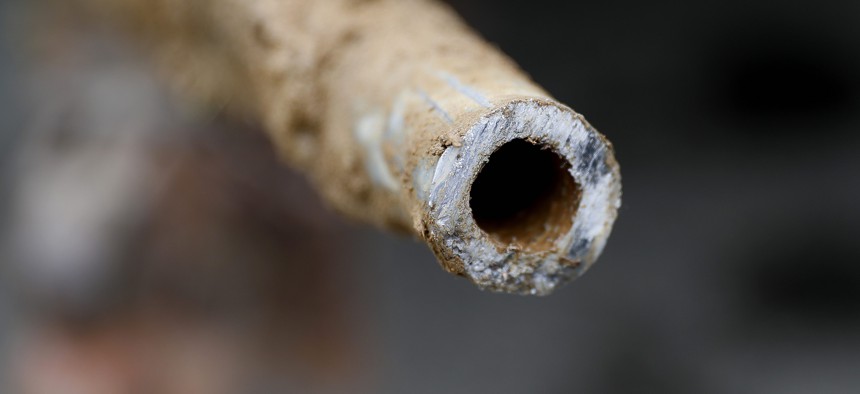 A lead pipe is shown after being replaced by a copper water supply line to a home in Flint, Mich., Friday, July 20, 2018.