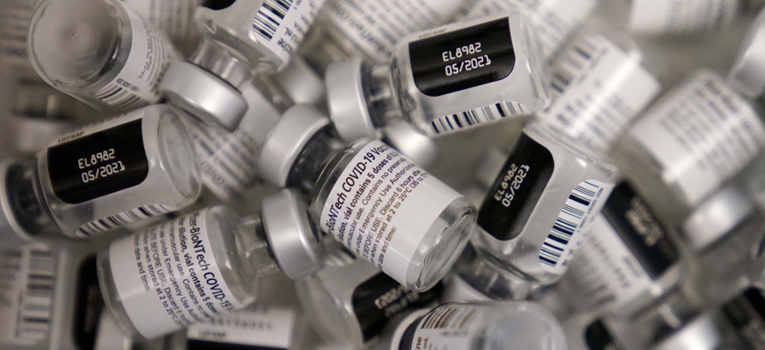 Empty vials of the Pfizer-BioNTech COVID-19 vaccine are seen at a vaccination center at the University of Nevada, Las Vegas, Friday, Jan. 22, 2021, in Las Vegas. 