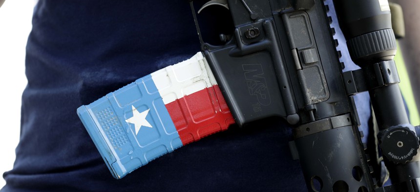 The ammo magazine is made to look like the Texas flag as gun rights advocates gather outside the Texas Capitol where Texas Gov. Greg Abbott held a round table discussion, Thursday, Aug. 22, 2019, in Austin, Texas.