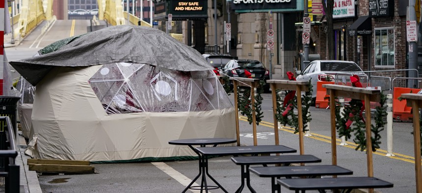 Kiosks for outdoor dining are situated in front of restaurants along Sixth St. in downtown Pittsburgh, Sunday, Jan. 17, 2021. 