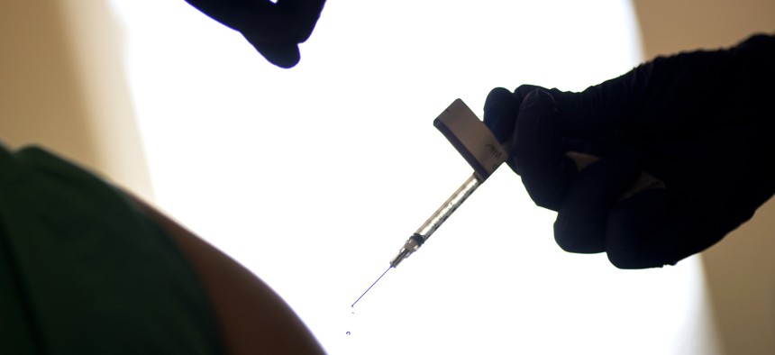 In this Tuesday, Dec. 15, 2020 file photo, a droplet falls from a syringe after a health care worker was injected with the Pfizer-BioNTech COVID-19 vaccine in Providence, R.I. 