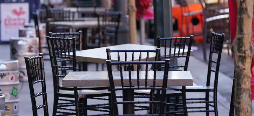 Empty tables and chairs are set up outside a restaurant that offers outside dining to deal with the rapid spread of the new coronavirus, Thursday, Nov. 12, 2020, in downtown Denver.