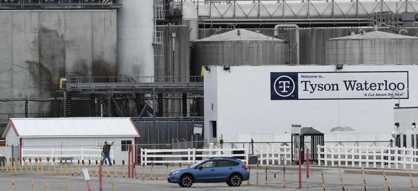 In this Friday, May 1, 2020, photo, a worker leaves the Tyson Foods plant in Waterloo, Iowa.