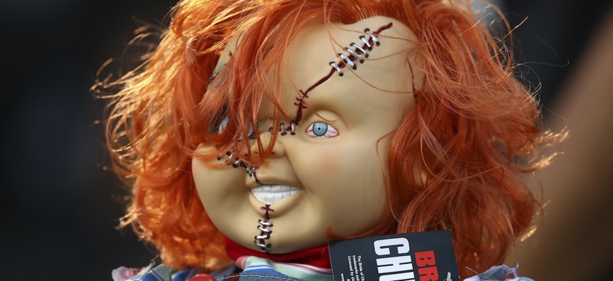 A Chucky doll is held by a fan during the first half of an NFL football game between the Oakland Raiders and the Los Angeles Rams in Oakland, Calif., Monday, Sept. 10, 2018.