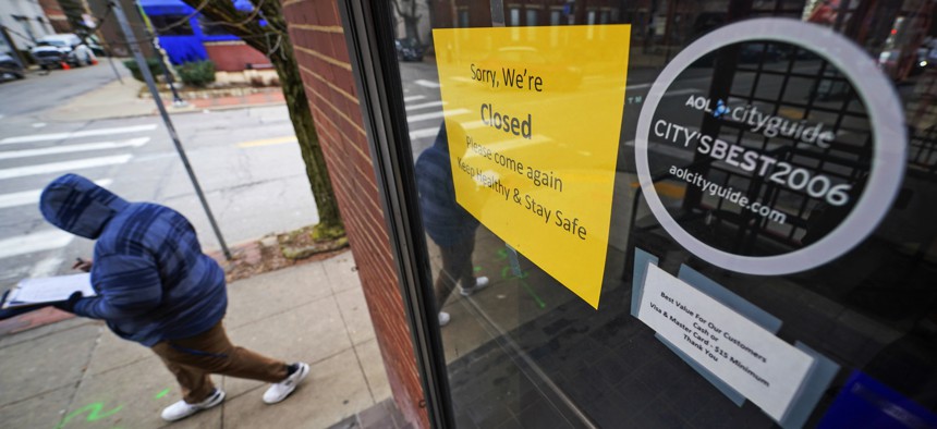 A sign hangs on the door of the Union Grill, temporarily closed due to COVID-19, in the Oakland neighborhood of Pittsburgh on Thursday, Jan. 28, 2021.