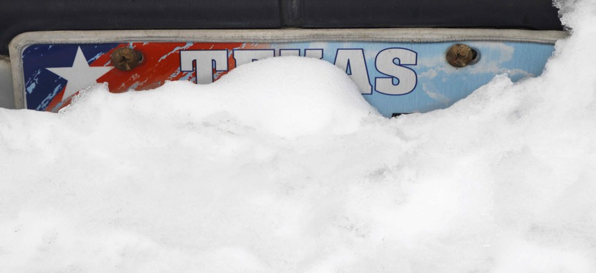 Snow begins to melt on a car in Euless, Texas, Thursday, Feb. 18, 2021.