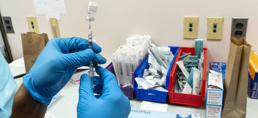 A pharmacist prepares a syringe with the Pfizer-BioNTech COVID-19 vaccine at a COVID-19 vaccination site at NYC Health + Hospitals Metropolitan, Thursday, Feb. 18, 2021, in New York. 