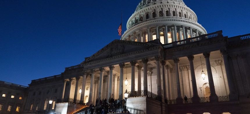 A bipartisan group of members of the House and Senate, walk back up the steps of the Capitol after holding a moment of silence for 500,000 U.S. COVID-19 deaths, Tuesday, Feb. 23, 2021, in Washington.