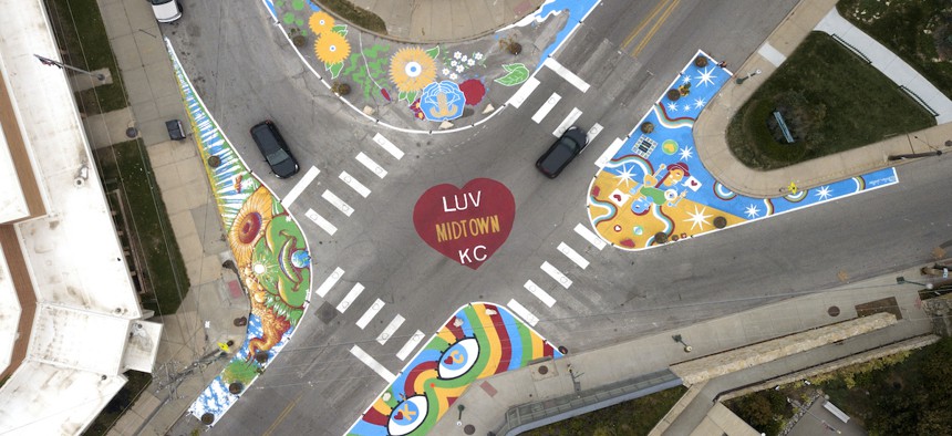 The four-way intersection is buffeted by four curb expansions featuring murals, which shorten crosswalks and reshape the streets.