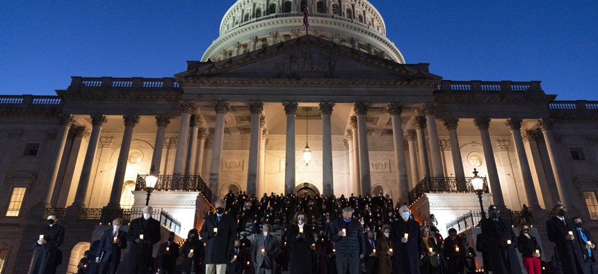 Members of Congress hold a moment of silence for 500,000 U.S. COVID-19 deaths, Tuesday, Feb. 23, 2021, on the east front steps of the Capitol in Washington. 