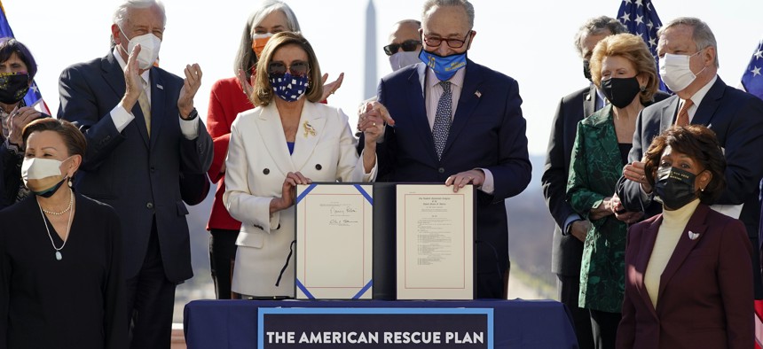 House Speaker Nancy Pelosi of Calif., and Senate Majority Leader Chuck Schumer of N.Y., poses after signing the $1.9 trillion COVID-19 relief bill during an enrollment ceremony on Capitol Hill, Wednesday, March 10, 2021, in Washington.