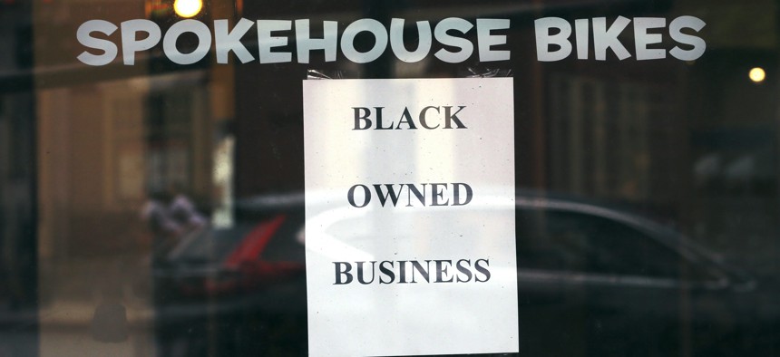 A sign in the window informs passersby that Spokehouse Bikes in the Upham's Corner neighborhood of Boston is a Black-owned business.                              